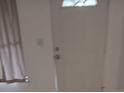 A clean, bright entryway featuring a white door and neutral walls at 6415 Ne 23Rd Ave, Ocala, FL 34479