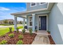 Inviting front porch featuring stylish seating and lush landscaping, enhancing curb appeal at 7695 Sw 64Th Street Rd, Ocala, FL 34474