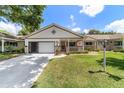 Charming single-story home with a cozy front porch, garage, and well-manicured landscaping at 8881 Sw 94Th St # E, Ocala, FL 34481