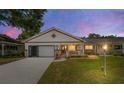 Charming single-story home with a cozy front porch, garage, and well-manicured landscaping at 8881 Sw 94Th St # E, Ocala, FL 34481