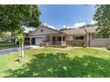 Charming single-story home with a cozy front porch and well-manicured landscaping at 8881 Sw 94Th St # E, Ocala, FL 34481