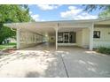 Attached carport featuring lattice work, access to the screen porch, and spacious layout at 8973 Sw 104Th Pl, Ocala, FL 34481