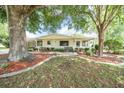 Well-maintained home featuring mature trees, landscaping, sidewalk, and green lawn at 8973 Sw 104Th Pl, Ocala, FL 34481