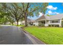 Scenic street view showcasing well-maintained homes with lush green lawns and mature trees at 9367 Sw 83Rd Ave # C, Ocala, FL 34481