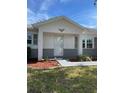 Charming front porch with brick accents and manicured landscaping at this inviting home at 9711 Sw 97Th Pl, Ocala, FL 34481
