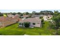 Aerial view of a well-kept backyard with a screened-in porch and green lawn at 13100 Se 93Rd Terrace Rd, Summerfield, FL 34491