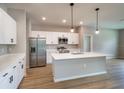 Modern kitchen with stainless steel appliances, an island with a breakfast bar, and ample counter space at 13138 Sw 78Th Cir, Ocala, FL 34473