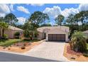 Inviting home with manicured landscaping, a brick driveway, and a classic American flag at 15776 Sw 11Th Terrace Rd, Ocala, FL 34473