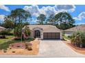Charming home featuring a brick driveway, well-maintained landscaping, and an American flag at 15776 Sw 11Th Terrace Rd, Ocala, FL 34473