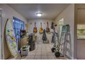 Eclectic living space with guitars, surfboard, tile floors and access to kitchen at 2508 India Palm Dr, Edgewater, FL 32141