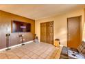 Cozy living room with tile floors, built-in media center, and a leather couch at 2508 India Palm Dr, Edgewater, FL 32141