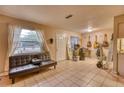 Eclectic living space with guitars, surfboard, tile floors, and leather couch at 2508 India Palm Dr, Edgewater, FL 32141