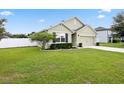 A charming, single-story home featuring a well-manicured lawn and tidy landscaping at 2984 Ne 43Rd Rd, Ocala, FL 34470
