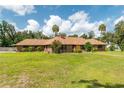 Beautiful brick home with sprawling green lawn and mature trees at 3555 Sw 24Th Avenue Rd, Ocala, FL 34471