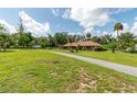 Brick home on sprawling green lot featuring mature trees and a long driveway at 3555 Sw 24Th Avenue Rd, Ocala, FL 34471