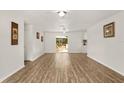 Bright living room showcasing hardwood floors and sliding glass doors to outdoor seating at 3640 Se 131St Ln, Belleview, FL 34420