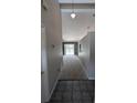 Inviting hallway with neutral walls, tile flooring and carpet ahead, providing a seamless transition throughout the home at 3650 Se 55Th Ct, Ocala, FL 34480
