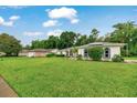 Attractive home with a neatly manicured lawn, featuring architectural details and a serene neighborhood setting at 3769 Grove View Ln, Port Orange, FL 32129