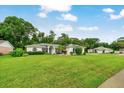 Well-maintained single-Gathering home with lush lawn and mature trees creating a peaceful and inviting setting at 3769 Grove View Ln, Port Orange, FL 32129