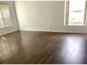 Bright living room featuring hardwood floors and natural light from large windows at 3983 Sw 51St Ct, Ocala, FL 34474