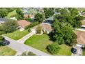 An aerial view of a well maintained home with a large yard, driveway and mature trees at 4555 Nw 6Th Cir, Ocala, FL 34475
