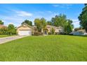 Inviting single-Gathering home with lush green lawn, established trees, and attached garage at 4555 Nw 6Th Cir, Ocala, FL 34475