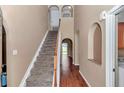 Bright foyer with staircase, archways and hardwood floors create an inviting entrance at 4602 Se 28Th St, Ocala, FL 34480