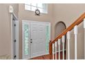 Elegant front door with decorative glass accents, complemented by a staircase and wood floors at 4602 Se 28Th St, Ocala, FL 34480