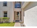 Inviting front entrance featuring a decorative glass door, manicured landscaping, and a well-lit walkway at 4602 Se 28Th St, Ocala, FL 34480