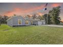 Charming single-story home boasts a manicured lawn, large driveway and detached two-car garage at 4661 Sw Gardenia Ct, Dunnellon, FL 34431