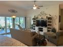 Inviting living room featuring a comfortable seating arrangement and sliding glass doors to the patio at 530 Casteel Ave, The Villages, FL 32163