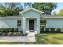 Inviting entrance with a covered porch and manicured landscaping leading to the front door at 5740 Nw 61St St, Ocala, FL 34482
