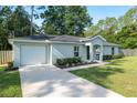 Well maintained single-story home with a two-car garage and landscaped front yard at 5740 Nw 61St St, Ocala, FL 34482
