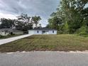 Charming single-story home with light blue exterior, well-maintained lawn, and paved driveway at 6422 Nw 62Nd Pl, Ocala, FL 34482