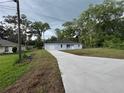 Charming single-story home with light blue exterior, well-maintained lawn, and long paved driveway at 6422 Nw 62Nd Pl, Ocala, FL 34482