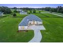 An impressive aerial view shows a modern home with a long driveway and sprawling green lawn at 7041 Ne 22Nd Court Rd, Ocala, FL 34479