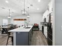 Modern kitchen featuring stainless steel appliances, a center island, and elegant pendant lighting at 710 Barwick St, Wildwood, FL 34785