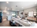 Bright, open-concept living room featuring contemporary decor, wood-look tile floors and abundant natural light at 7364 Sw 133 Ne Loop, Ocala, FL 34473