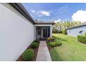 Inviting screened front porch showcasing the home's entrance and manicured landscaping at 7707 Sw 94Th Cir, Ocala, FL 34481