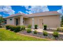 Attractive home exterior with manicured landscaping, complemented by a welcoming entryway at 7765 Sw 86Th Loop, Ocala, FL 34476