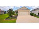 Beautiful home with a two car garage, mature landscaping, and a well-maintained driveway at 7765 Sw 86Th Loop, Ocala, FL 34476