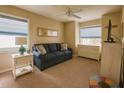Comfortable bedroom with neutral walls, a ceiling fan, and ample natural light from two windows at 8187 Sw 60Th Ter, Ocala, FL 34476