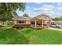 Inviting home with a cozy front porch framed by lush landscaping and manicured lawn at 8677 Sw 95Th Ln # A, Ocala, FL 34481