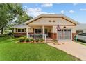 Welcoming home with inviting porch, complemented by a lush lawn and attached garage at 8677 Sw 95Th Ln # A, Ocala, FL 34481