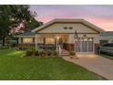Charming home with cozy porch, manicured lawn, and warm evening glow at 8677 Sw 95Th Ln # A, Ocala, FL 34481