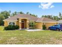 Inviting single-story home with manicured lawn and two-car garage, featuring fresh exterior paint and a lovely front yard at 9562 Sw 45Th Ave, Ocala, FL 34476