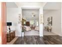 Open foyer showcasing hardwood floors, decorative sconces, and views into the living room with stylish decor at 9562 Sw 45Th Ave, Ocala, FL 34476