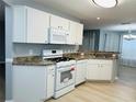 Bright kitchen featuring white appliances, ample cabinetry, and durable countertops at 9706 Sw 92Nd Place Rd, Ocala, FL 34481