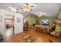 Cozy living room with hardwood floors, comfortable seating, and a ceiling fan at 9710 Sw 96Th St, Ocala, FL 34481