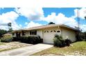 This home features an attached garage and a well-manicured lawn that enhances the property's curb appeal at 16905 Sw 30Th Avenue Rd, Ocala, FL 34473